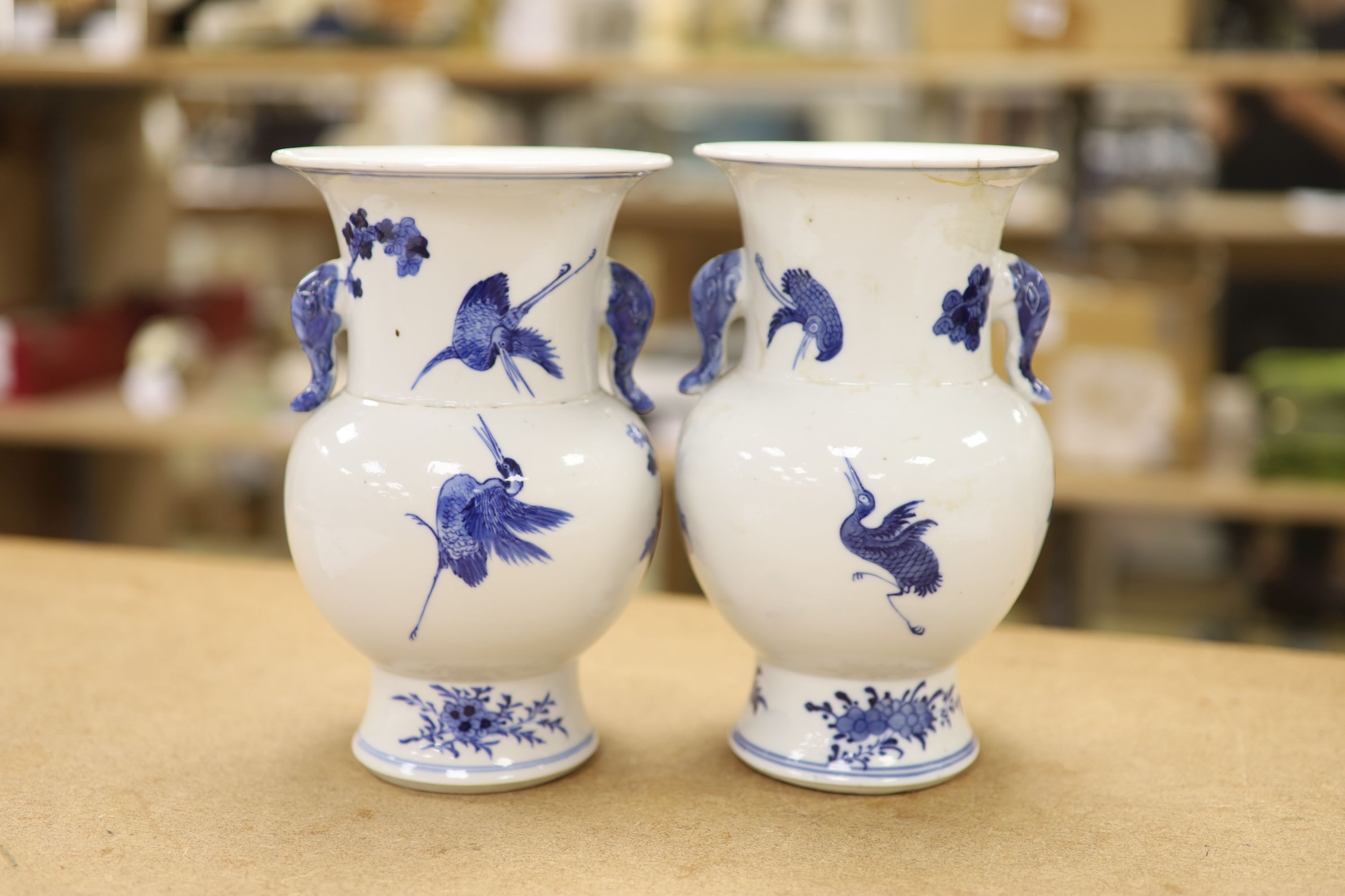 A pair of Chinese blue and white 'phoenix' vases, Kangxi marks but late 19th century, height 20cm (a.f.)